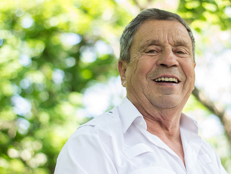 Who is a candidate for implant-supported dentures?